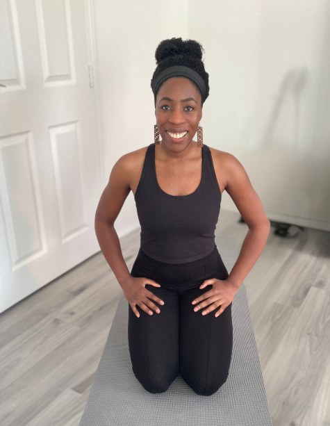 Rachel Abiodun kneeling on a mat